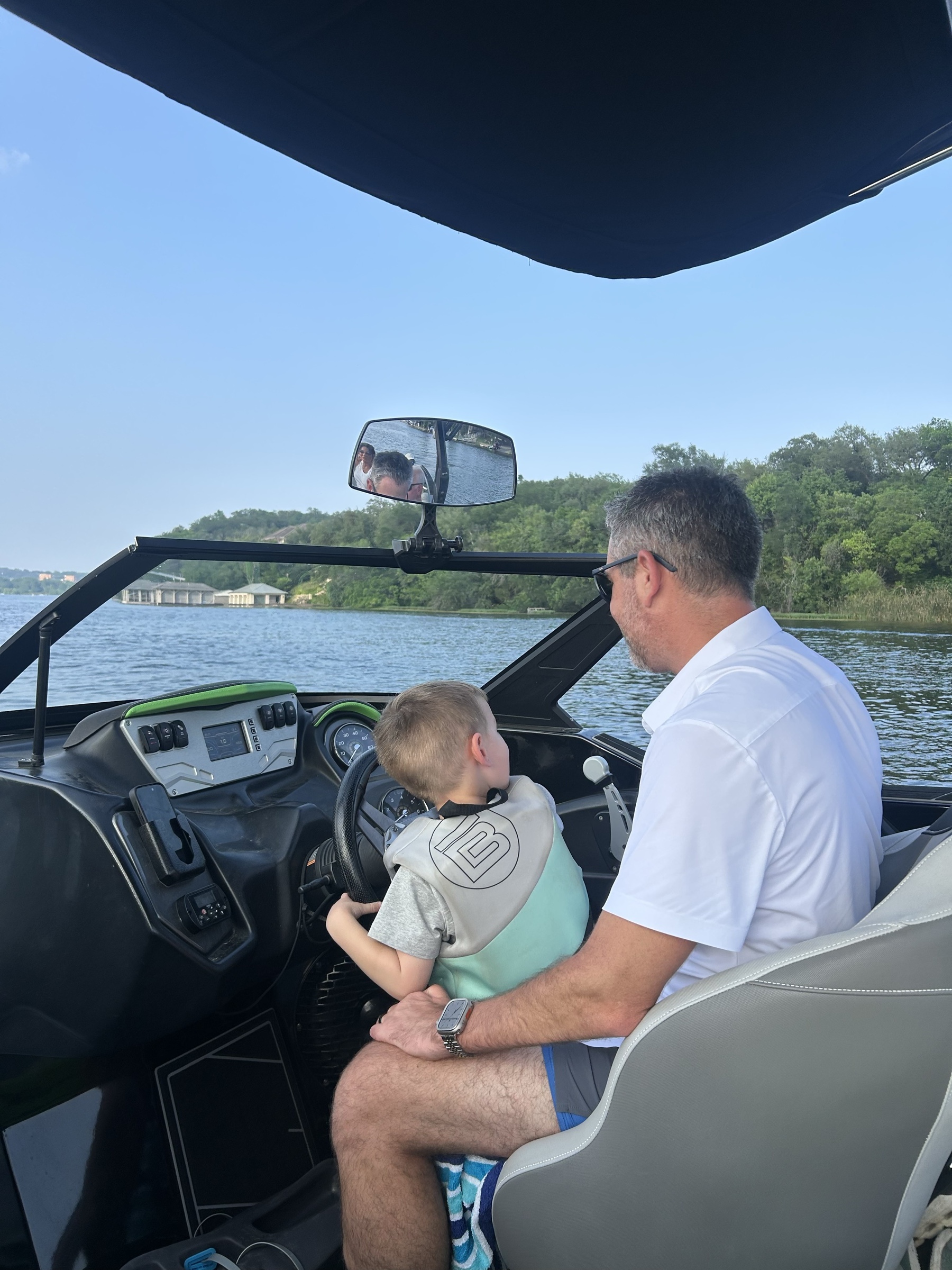 Jonathan and Rowdy at the wheel of the wakeboat on Canyon Lake