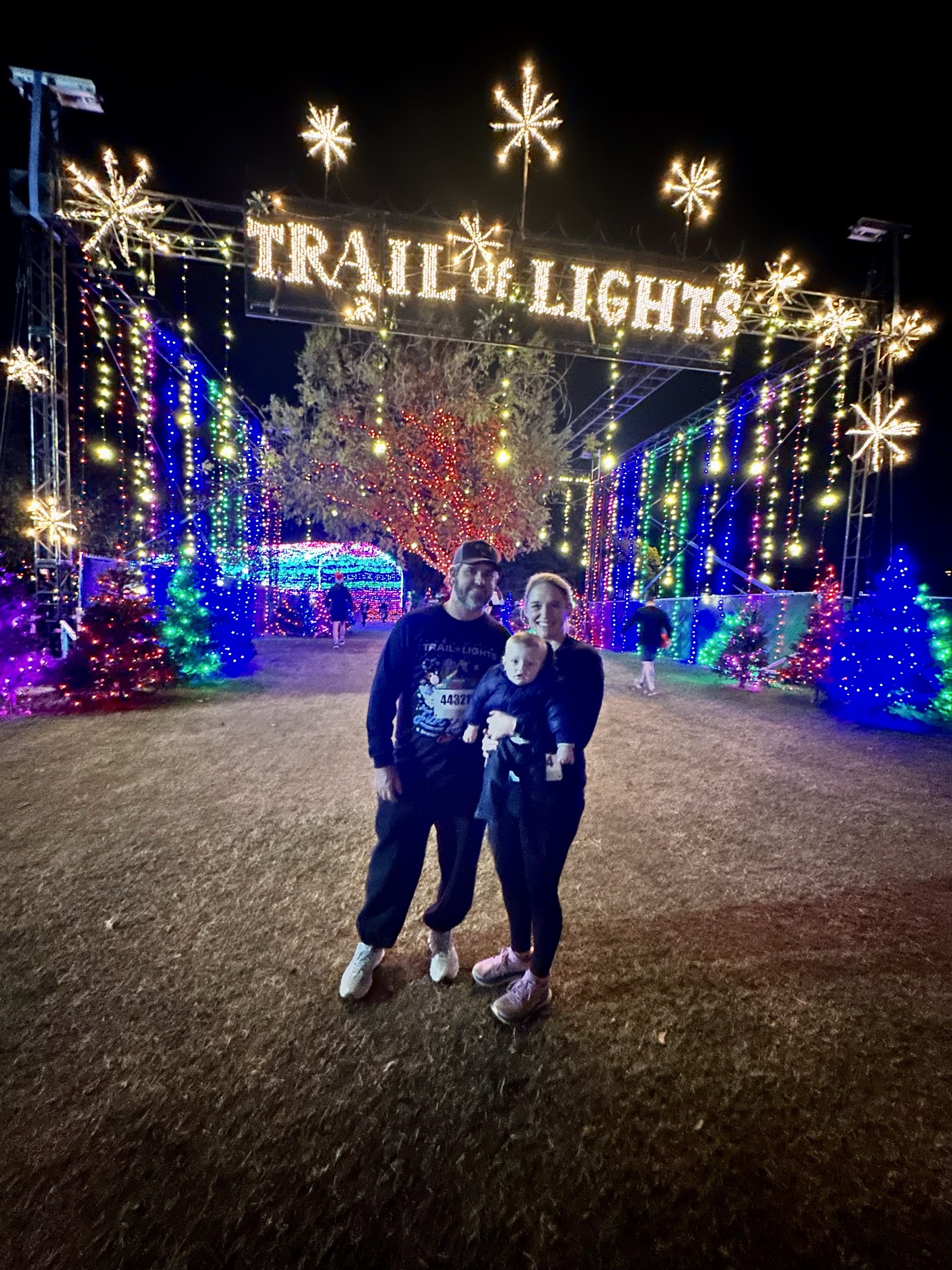 Family at the entrance to the Austin Trail of Lights