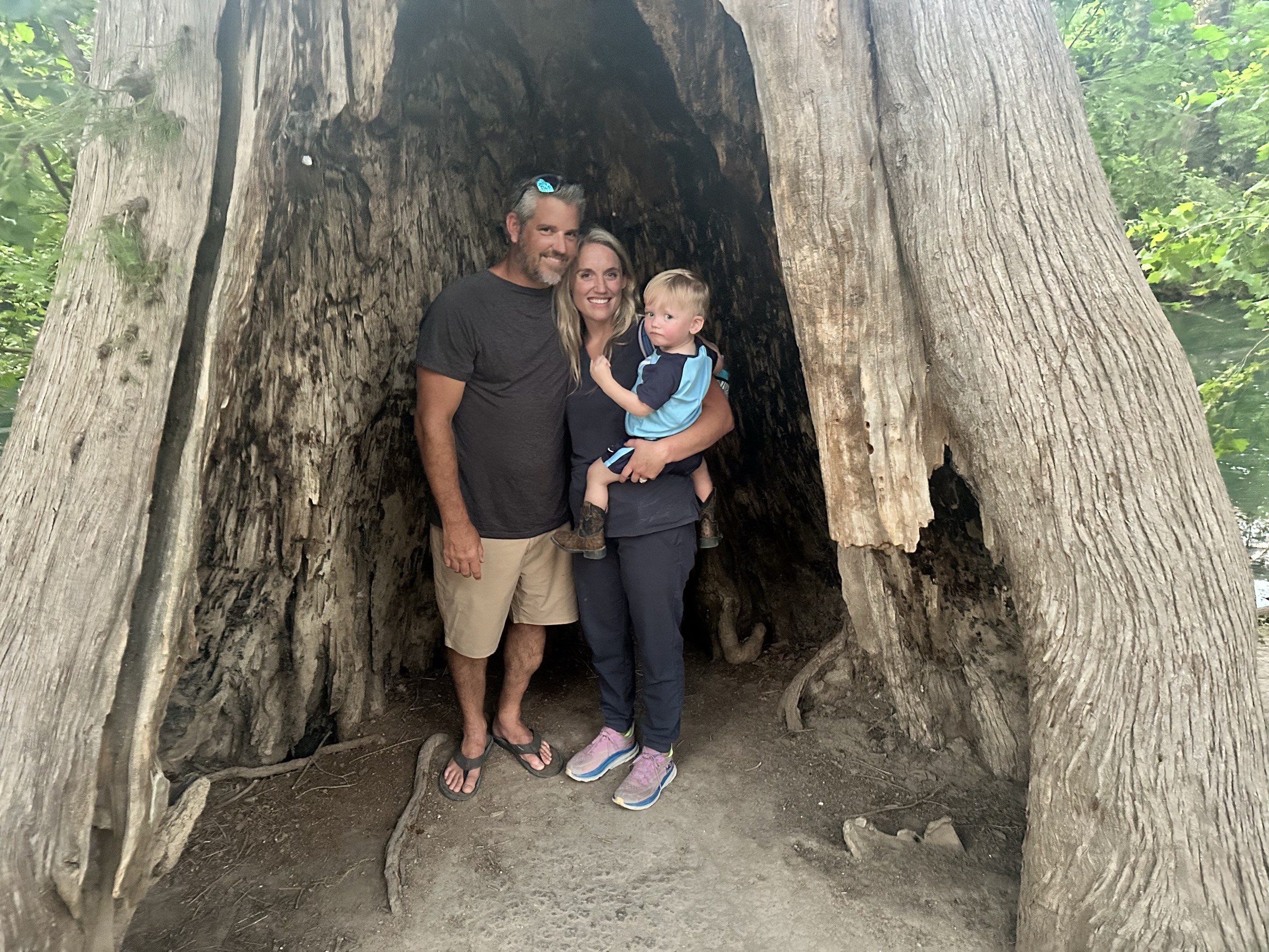 Family in a hollow cypress tree in Wimberley, Texas